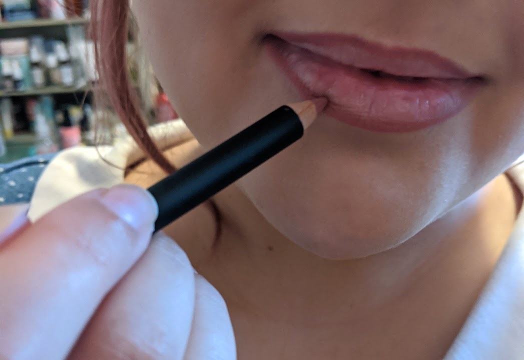 lining lips with pink pencil